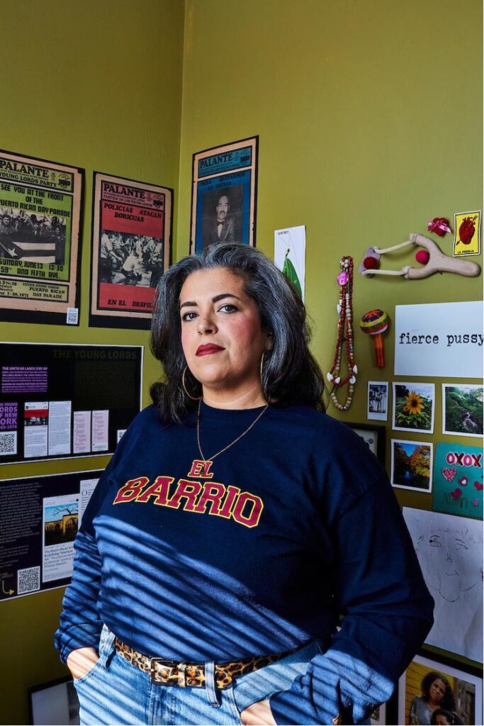 Portrait of creator Christina Delgado with images and posters behind